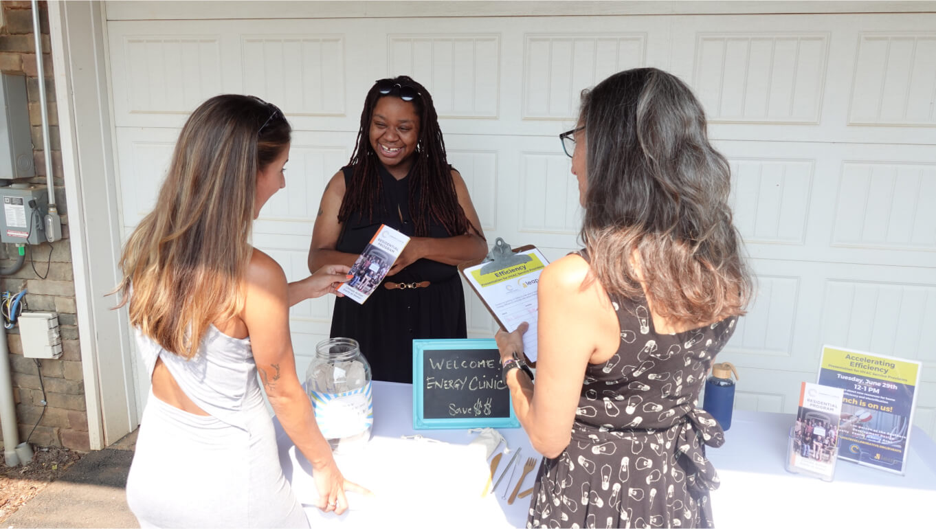 Three women standing at an energy clinic